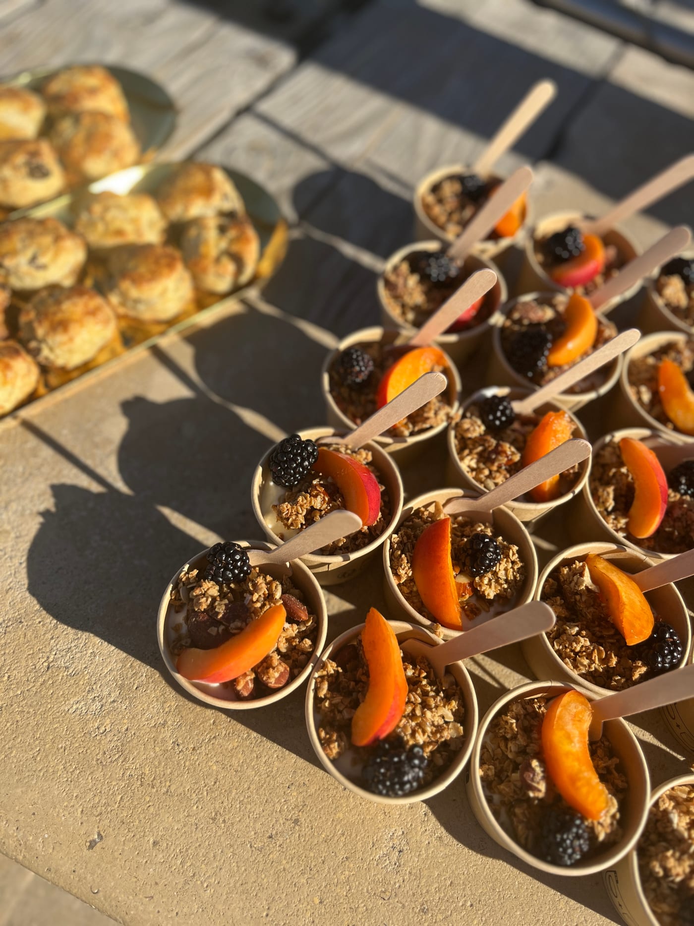 Coupes individuelles de yaourt et granola maison aux abricots et mûres, et scones tout juste sortis du four